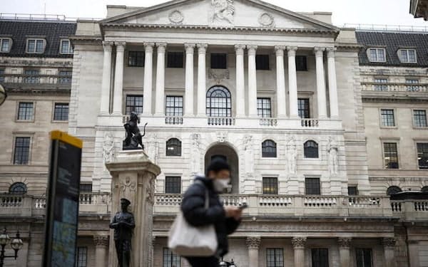 FILE PHOTO: A person walks past the Bank of England in the City of London financial district in London, Britain, January 23, 2022. REUTERS/Henry Nicholls/File Photo