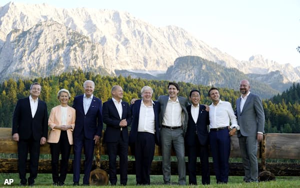 Members of the G7 from left, Prime Minister of Italy Mario Draghi, European Commission President Ursula von der Leyen, President Joe Biden, German Chancellor Olaf Scholz, British Prime Minister Boris Johnson, Canadian Prime Minister Justin Trudeau, Prime Minister of Japan Fumio Kishida, French President Emmanuel Macron and European Council President Charles Michel stand for a photo at Schloss Elmau following their dinner at G7 Summit in Elmau, Germany, Sunday, June 26, 2022. The bench behind them became famous when former German Chancellor Angela Merkel and former President Barack Obama were photographed talking by it. (AP Photo/Susan Walsh)