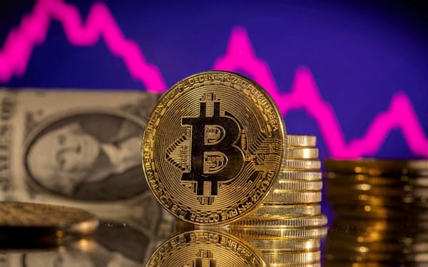 FILE PHOTO: A representations of cryptocurrency Bitcoin is seen in front of a stock graph and U.S. dollar in this illustration taken, January 24, 2022. REUTERS/Dado Ruvic/Illustration/File Photo