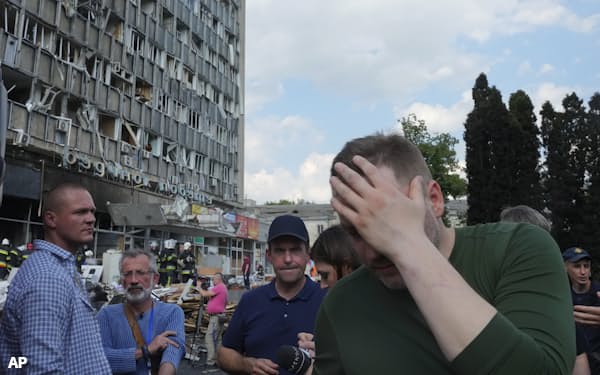 Ukrainian Interior Minister Denys Monastyrsky, center right, reacts at the scene of a building that was damaged by a deadly Russian missile attack in Vinnytsia, Ukraine, Thursday, July 14, 2022. (AP Photo/Efrem Lukatsky)