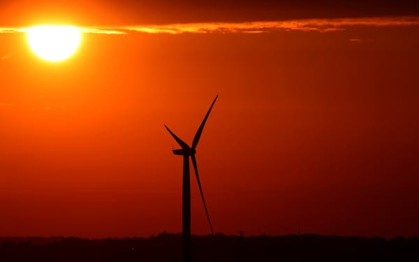 FILE PHOTO: The sun rises behind an electric power windmill in Halle, Belgium September 11, 2019.  REUTERS/Yves Herman/File Photo