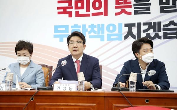 　韓国の与党「国民の力」の会議に同席した李俊錫代表（右）と尹錫悦大統領の側近・権性東氏（中央）＝7月、ソウル（聯合＝共同）