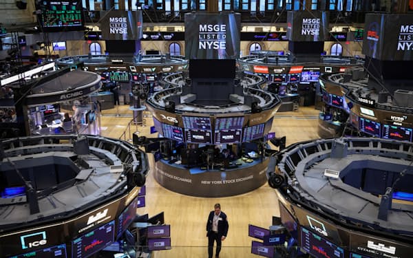 A trader walks on the trading floor at the New York Stock Exchange (NYSE) in Manhattan, New York City, U.S., August 3, 2022. REUTERS/Andrew Kelly