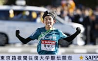 往路優勝のゴールテープを切る青学大の黒田。山上り5区で従来の記録を1分55秒更新する異次元の区間新記録をたたき出した=共同