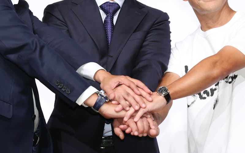 記者会見で握手する(右から)ZOZO創業者の前沢氏、沢田社長、ヤフーの川辺社長(12日、東京都目黒区)