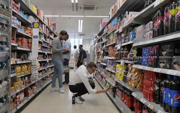FILE - Shoppers buy food in a supermarket in London, on Aug. 17, 2022. Britain’s Conservative government is expected to publish an emergency budget statement Friday, Sept. 23, 2022 outlining how it plans to slash taxes, tame soaring inflation and boost economic growth as a recession looms on the horizon. (AP Photo/Frank Augstein, File)