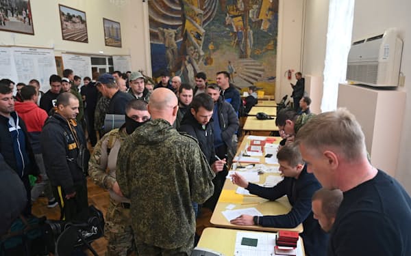 招集に応じ、基地に向かうための手続きをとるロシア軍の予備役兵士（26日、ロストフ州）＝ロイター