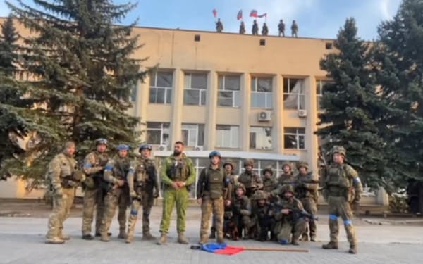 奪還したリマンの行政庁舎前に立つウクライナ兵（１日）＝ウクライナ軍・ロイター
