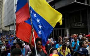 A demonstator holds a Venezuelan flag during a march organized by the education sector to demand the release of President Nicolas Maduro and his wife Cilia Flores, following their capture by U.S. forces, in Caracas, Venezuela January 15, 2026. REUTERS/Maxwell Briceno A demonstator holds a Venezuelan flag during a march organized by the education sector to demand the release of President Nicolas Maduro and his wife Cilia Flores, following their capture by U.S. forces, in Caracas, Venezuela January 15, 2026. REUTERS/Maxwell Briceno