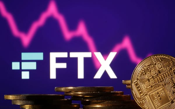 Representations of cryptocurrencies are seen in front of displayed FTX logo and decreasing stock graph in this illustration taken November 10, 2022. REUTERS/Dado Ruvic/Illustration