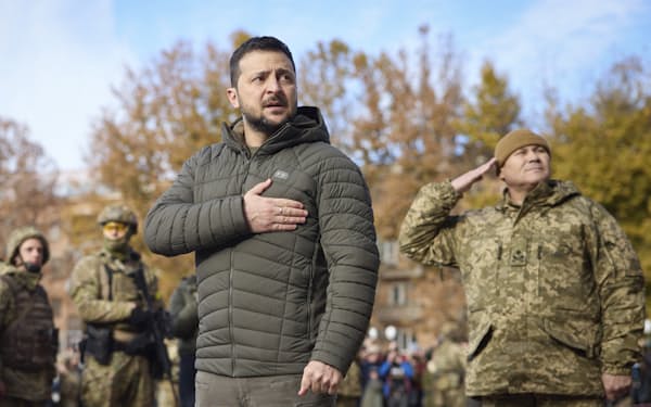 ウクライナ軍が奪還した同国南部ヘルソンを訪問し、胸に手をあてるゼレンスキー大統領（14日）＝ウクライナ大統領府提供・ＡＰ