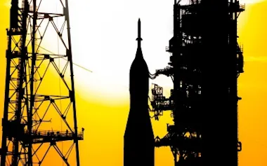 太陽が沈む中、アルテミス2のSLSロケットと宇宙船「オリオン」を米フロリダ州ケネディ宇宙センターの39B発射台へと運ぶNASAの自走式陸上輸送機「クローラー・トランスポーター2(CR-2)」。(BRANDON HANCOCK, NASA)