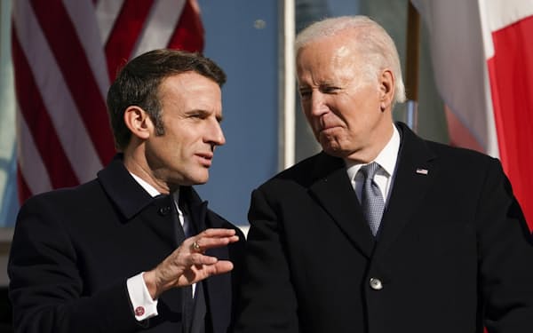 １日、会談前の式典で言葉を交わすマクロン仏大統領（左）とバイデン米大統領（米ホワイトハウス）＝ＡＰ
