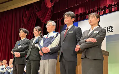 新入社員と握手するスズキの鈴木俊宏社長(右から3人目、1日、浜松市)