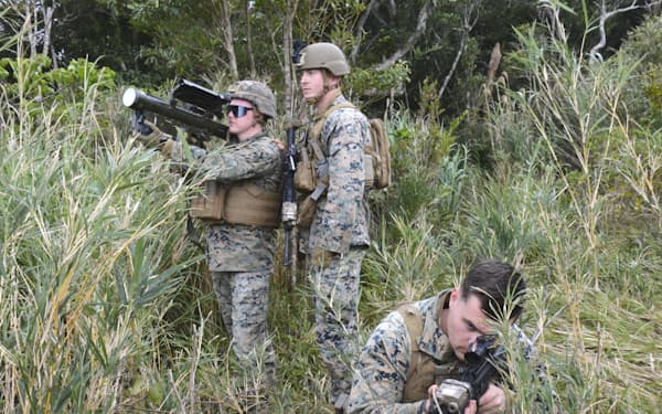 沖縄県内の米軍施設を離島に見立て実施された訓練で、米軍機が離着陸する地点の安全を確保する海兵隊員（2022年2月、沖縄本島北部の北部訓練場）＝共同