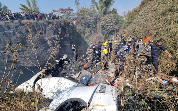 15日、ネパール中部ポカラの航空機墜落現場に駆けつけた救助隊員ら＝Bijay Neupane提供・ロイター
