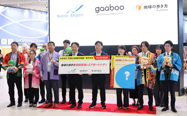 制作発表会に出席した成田空港や周辺自治体の関係者ら(21日、NAA提供)