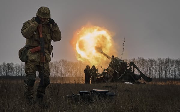 バフムト近郊でロシア軍を砲撃するウクライナ軍兵士（２０２２年１２月１６日）＝AP