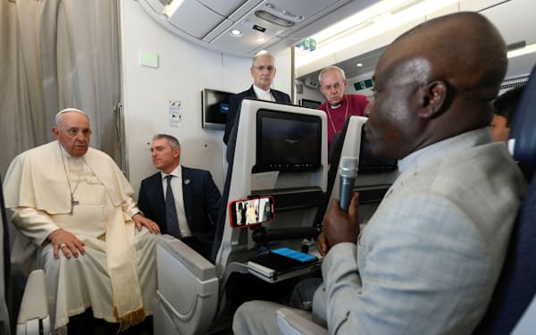 ローマに向かう機内で取材に対応する教皇フランシスコ（5日）＝ロイター