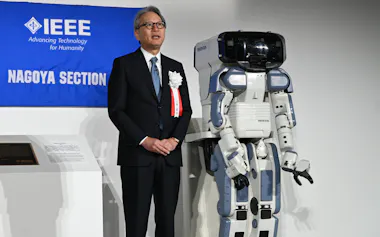 ホンダの三部敏宏社長㊧と二足歩行ロボット「P2」(28日、埼玉県和光市)