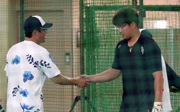 打撃特訓を終え、投手役を務めた古田臨時コーチ（左）と握手するヤクルト・村上（10日、浦添）＝共同