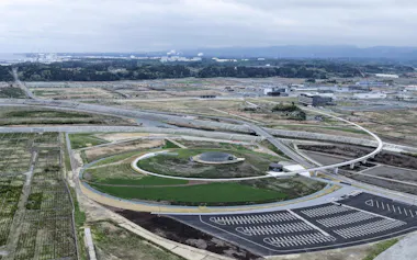 福島県復興祈念公園。左奥は東京電力福島第1原発(4月)=共同