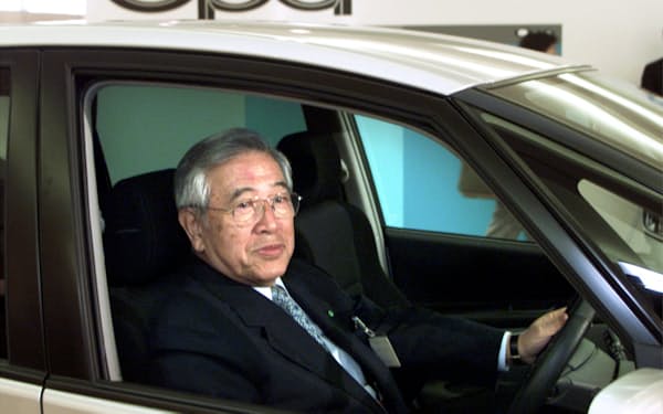 FILE PHOTO: The then Toyota Motor Corporation's Honorary Chairman Shoichiro Toyoda sits in the driver's seat of its new midsize vehicle Opa after unveiling the car in Tokyo May 24, 2000./File Photo