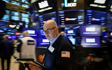 FILE PHOTO: Traders work on the floor at the New York Stock Exchange (NYSE) in New York City, U.S., May 7, 2026. REUTERS/Brendan McDermid/File Photo