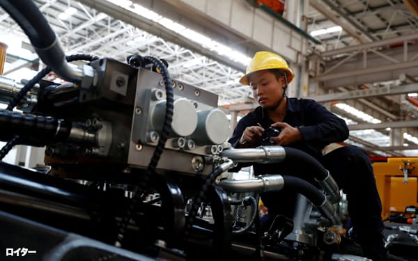 FILE PHOTO: An employee works at a manufacturing plant of Sany Heavy Industry Co. during a government-organised tour of manufacturers based in Changsha, Hunan province, China, October 19, 2019.  REUTERS/Thomas Peter/File Photo