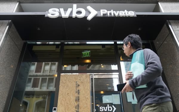 A pedestrian passes a Silicon Valley Bank Private branch in San Francisco, Monday, March 13, 2023. Depositors withdrew savings and investors broadly sold off bank shares Monday as the federal government raced to reassure Americans that the banking system was secure after two bank failures. Regulators closed the Silicon Valley Bank on Friday after depositors rushed to withdraw their funds all at once.  (AP Photo/Jeff Chiu)