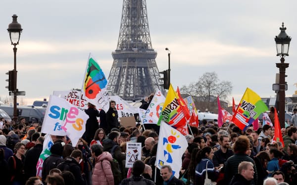 パリのコンコルド広場に集まり、年金改革の強行採択に抗議する人々（16日）＝ロイター