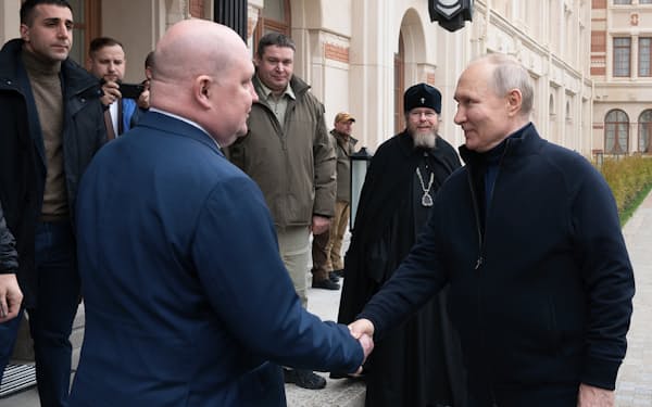 プーチン氏（右）は18日にはクリミア半島の港湾都市セバストポリを訪れて実効支配をアピールしていた＝スプートニク・ＡＰ