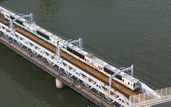 隅田川にかかる橋梁を渡る東武鉄道のスカイツリートレイン