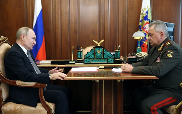 １７日、ロシアのショイグ国防相㊨はプーチン大統領に極東での大規模な軍事演習について報告した＝ロイター
