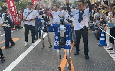 交通規制された公道で二足歩行しながら踊りを披露するヒト型ロボット(岡山県倉敷市、25日)