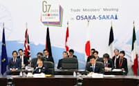 G7貿易相会合の閉会セッションであいさつする上川外相（左）と西村経産相（29日、大阪市北区）