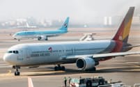 大韓航空とアシアナ航空の経営統合は競争法当局の審査のために遅れている