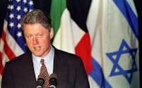 President Bill Clinton comments on the new peace agreement between Israel and Jordan with a backdrop of the US., Jordanian and Israeli flags, to reporters in Albuquerque, October 17