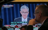 FILE PHOTO: A trader watches U.S. Federal Reserve Chairman Jerome Powell on a screen during a news conference following the two-day Federal Open Market Committee (FOMC) policy meeting, on the floor at the New York Stock Exchange (NYSE) in New York, U.S., March 20, 2019. REUTERS/Brendan McDermid/File Photo