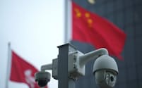 Chinese and Hong Kong flags fly near surveillance cameras, in Hong Kong, China January 30, 2024. REUTERS/Lam Yik