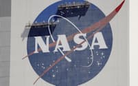 FILE - Workers on scaffolding repaint the NASA logo near the top of the Vehicle Assembly Building at the Kennedy Space Center in Cape Canaveral, Fla., Wednesday, May 20, 2020. After a yearlong study into UFOs, NASA is releasing a report Thursday, Sept. 14, 2023, on what it needs to better understand unidentified flying objects from a scientific point of view. (AP Photo/John Raoux, File)