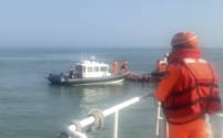 台湾の金門島付近で転覆した船舶を捜査する沿岸警備隊（14日、金門島）＝台湾沿岸警備当局・AP
