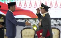 Indonesian Defense Minister Prabowo Subianto, right, salute after he receives four-star general epaulettes from President Joko Widodo during a ceremony at the Armed Forces Headquarters in Jakarta, Indonesia, Wednesday, Feb. 28, 2024. President Joko Widodo on Wednesday awarded an honorary four-star general rank to Defense Minister Subianto, a former high-ranking army officer who is linked to human rights abuses and who emerged as the apparent winner of the Feb. 14 presidential election.(AP Photo/Achmad Ibrahim)