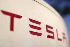 FILE - The logo for the Tesla Supercharger station is seen in Buford, Ga, April 22, 2021. Two men are accused of starting a business in China using battery manufacturing technology pilfered from Tesla and trying to sell the proprietary information, federal prosecutors in New York said Tuesday, March 19, 2024. (AP Photo/Chris Carlson, File)