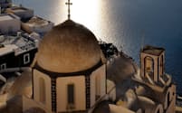 ギリシャ、サントリーニ島に立つ教会。海の向こうに見えるのはカメニ火山の頂上。（PHOTOGRAPH BY MARC STEINMETZ / VISUM/REDUX）