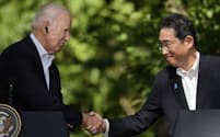 FILE - U.S. President Joe Biden, left, shakes hands with Japan's Prime Minister Fumio Kishida during a joint news conference with South Korean President Yoon Suk Yeol, not visible,  on Aug. 18, 2023, at Camp David, the presidential retreat, near Thurmont, Md.  Prime Minister Kishida is making an official visit to the United States this week. He will hold a summit with President Biden that's meant to achieve a major upgrading of their defense alliance.(AP Photo/Andrew Harnik, File)