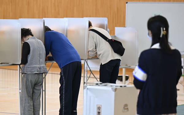 衆院島根1区補欠選挙で、投票用紙に記入する有権者（28日、松江市）=共同