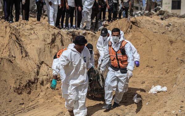 ガザ南部ハンユニスで、住民の遺体を収容するガザ当局者ら=21日（ゲッティ=共同）