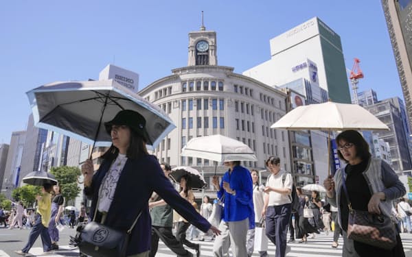東京・銀座で日傘を差して行き交う人たち（4日午後）=共同