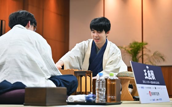 第73期将棋王座戦第1局で伊藤匠叡王(手前)を破り、感想戦で笑顔を見せる藤井聡太王座(4日、シンガポール) 第73期将棋王座戦第1局で伊藤匠叡王(手前)を破り、感想戦で笑顔を見せる藤井聡太王座(4日、シンガポール)